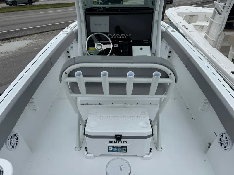 Slide: The Image of 2025 Wellcraft 223 Fisherman boat interior with Igloo cooler and rod holders. - 6