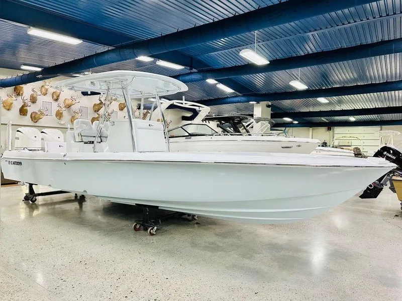 The Image of 2025 Contender 29BAY boat displayed in a showroom with blue ceiling and bright lighting. - 0