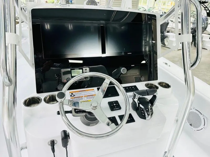 Slide: The Image of 2025 Contender 29BAY boat dashboard with steering wheel and dual screens. - 1