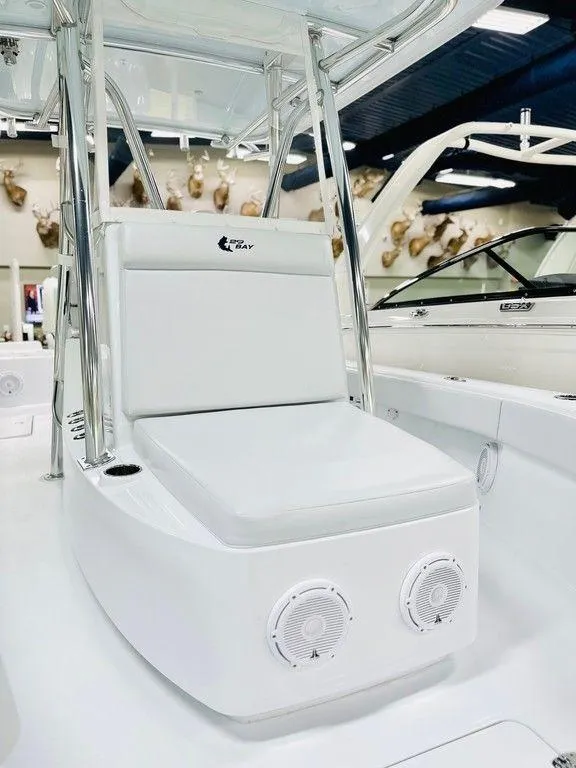 Slide: The Image of 2025 Contender 29BAY boat interior with white seating and speakers. - 12