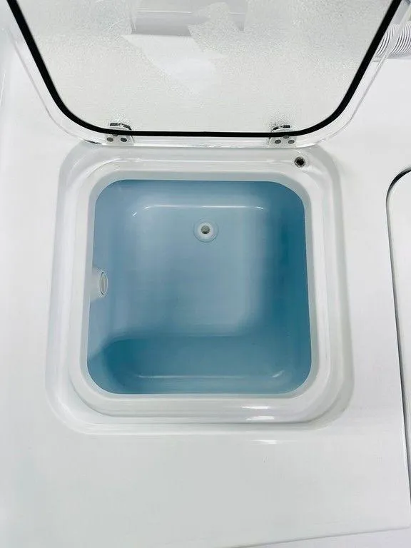 Slide: The Image of 2025 Contender 29BAY boat livewell with open lid, showcasing interior design. - 14