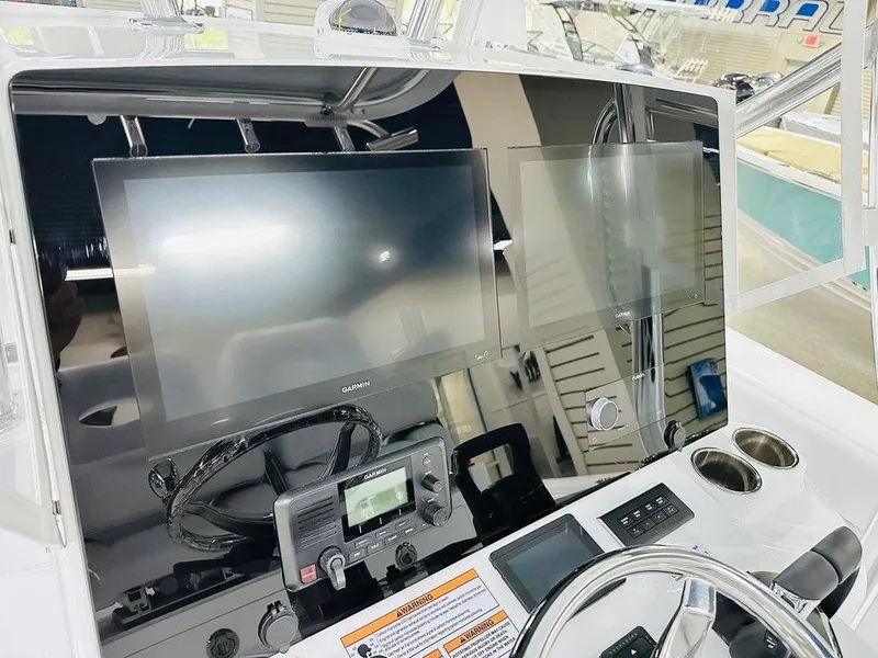 Slide: The Image of 2025 Contender 29BAY boat dashboard with modern navigation screens and controls. - 2