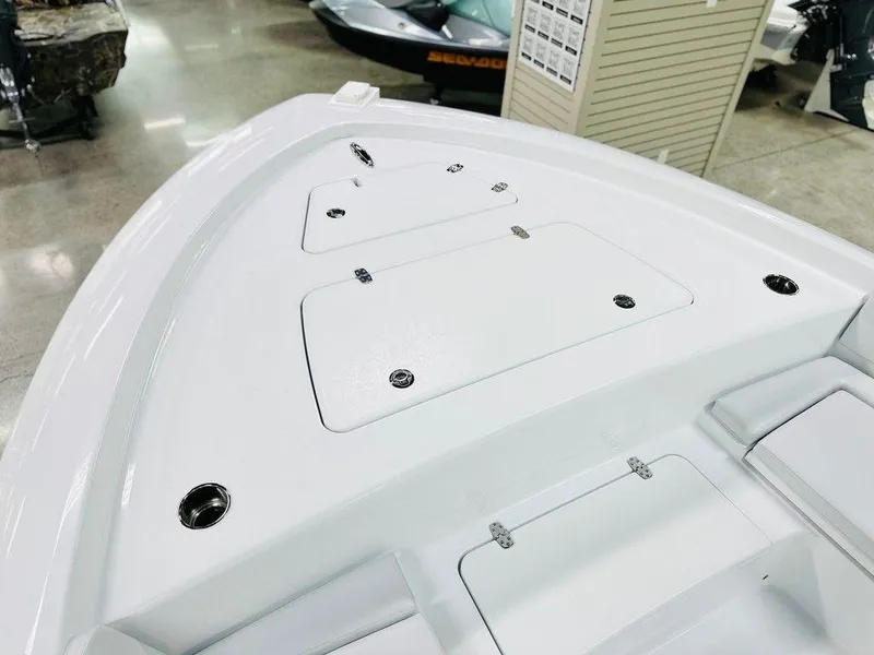 Slide: The Image of 2025 Contender 29BAY boat deck with storage compartments in showroom setting. - 8