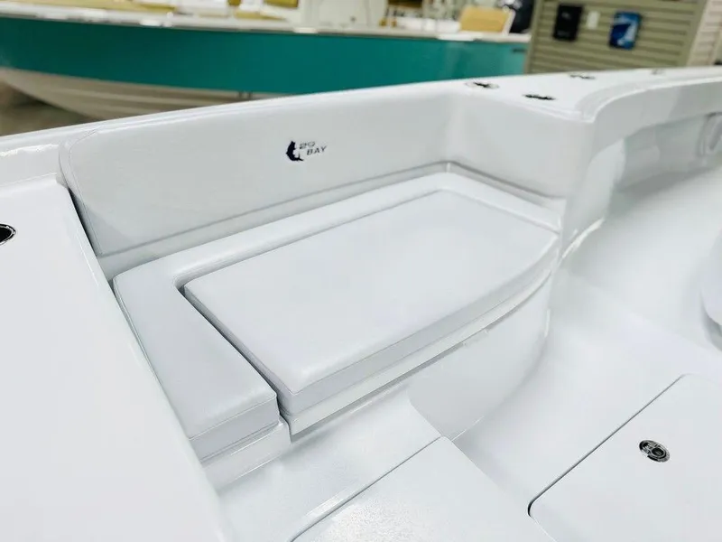 Slide: The Image of 2025 Contender 29BAY boat interior, featuring sleek white seating and storage compartments. - 9
