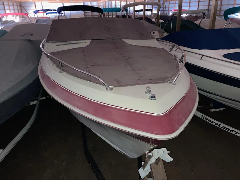 Slide: The Image of 1988 Cobalt 23 boat with cover in storage facility. - 0