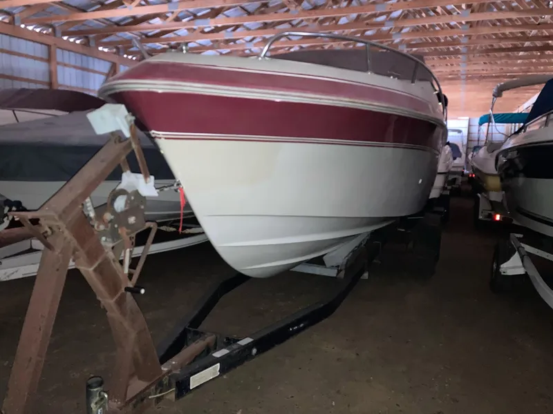 Slide: The Image of 1988 Cobalt 23 boat in storage, featuring a red and white exterior. - 1