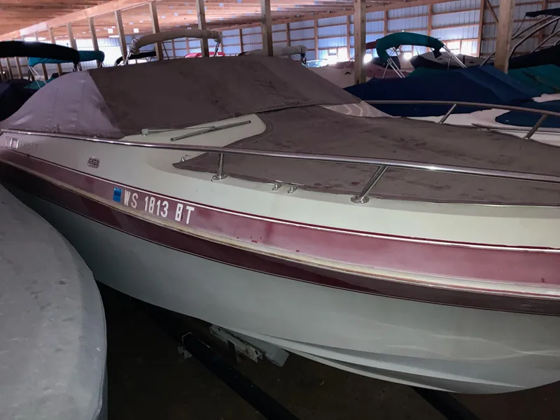 Slide: The Image of 1988 Cobalt 23 boat in storage, covered and docked indoors. - 3