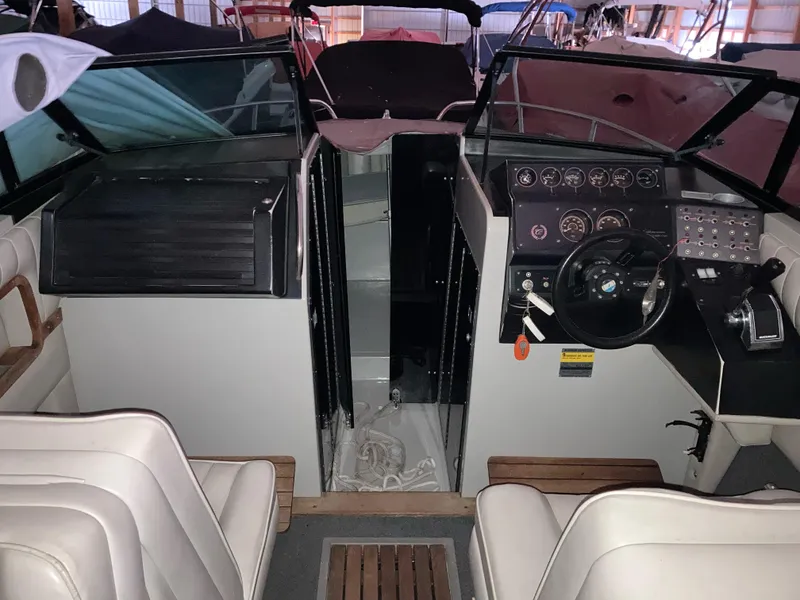 Slide: The Image of Interior of a 1988 Cobalt 23 boat with steering wheel and dashboard controls. - 5