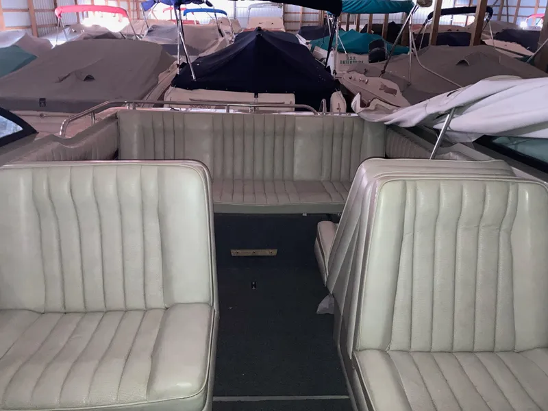 Slide: The Image of 1988 Cobalt 23 boat interior with beige seating, stored under covers. - 8