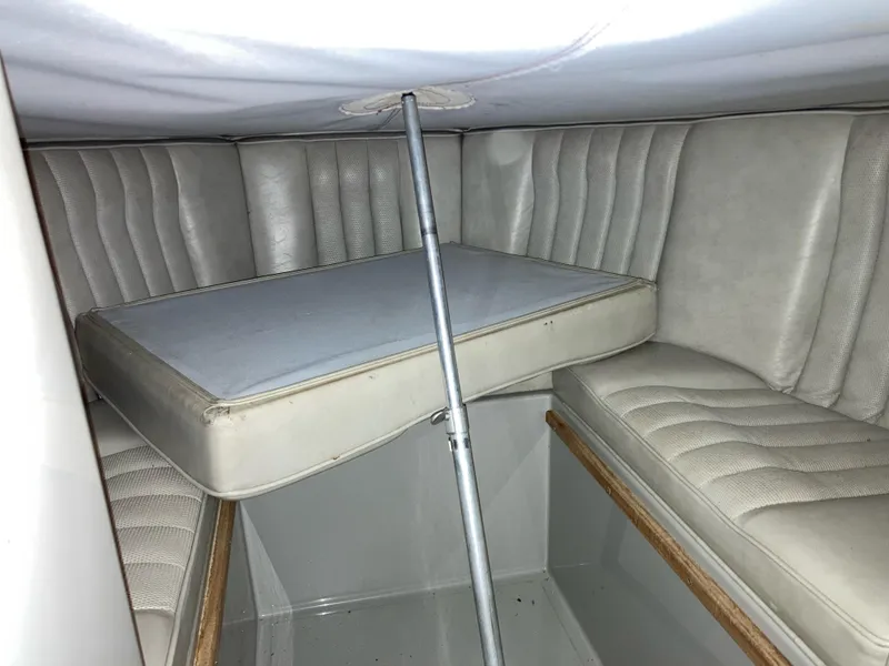 Slide: The Image of Interior cabin of a 1988 Cobalt 23 boat with cushioned seating. - 9
