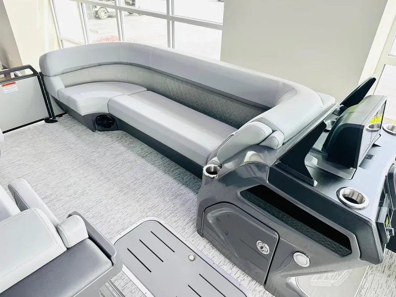 Slide: The Image of 2025 Bennington 24 MSB pontoon boat interior with sleek gray seating and modern console design. - 7