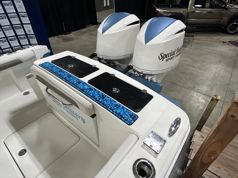 Slide: The Image of 2019 Albemarle 27 Dual Console boat with twin outboard motors displayed indoors. - 11