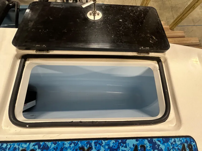 Slide: The Image of Open storage compartment on a 2019 Albemarle 27 Dual Console boat. - 16