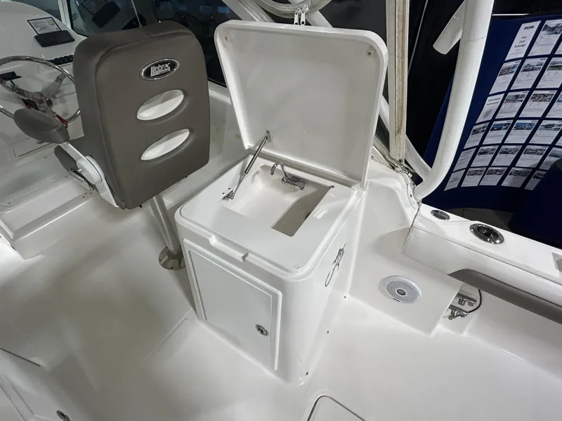Slide: The Image of 2019 Albemarle 27 Dual Console boat interior with open storage compartment and seating. - 18