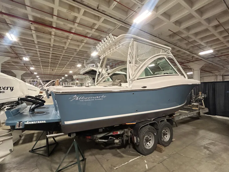 Slide: The Image of 2019 Albemarle 27 Dual Console boat displayed indoors on a trailer. - 2