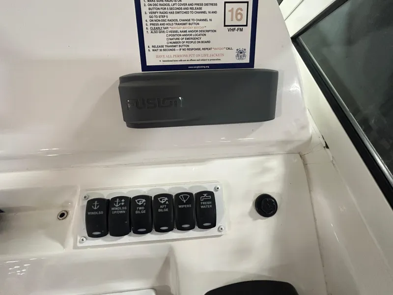 Slide: The Image of Control panel of 2019 Albemarle 27 Dual Console boat with labeled switches and Fusion audio system. - 25