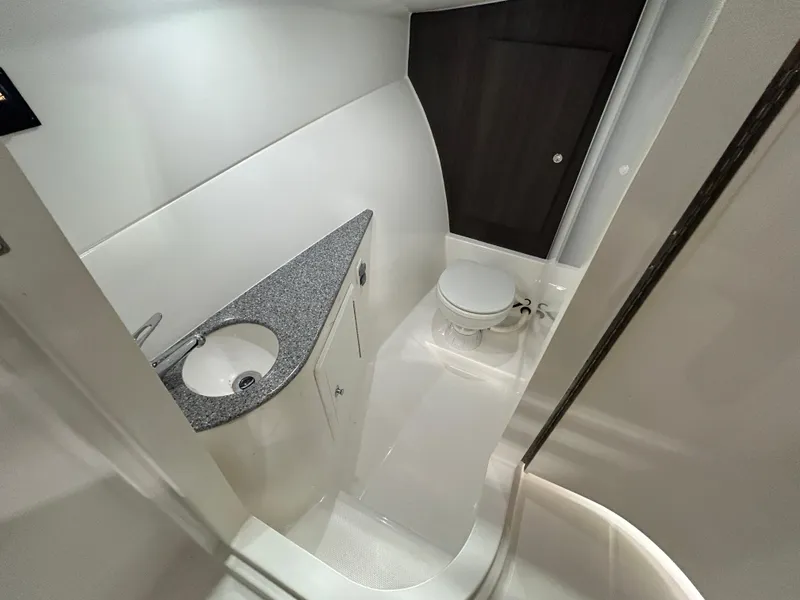 Slide: The Image of 2019 Albemarle 27 Dual Console boat bathroom with sink and toilet, modern design. - 29