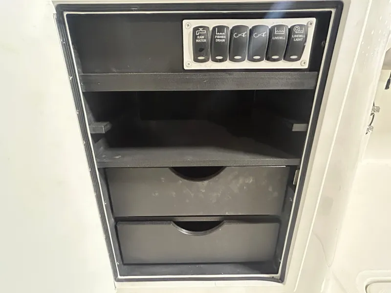 Slide: The Image of 2019 Albemarle 27 Dual Console storage compartment with control panel and drawers. - 42