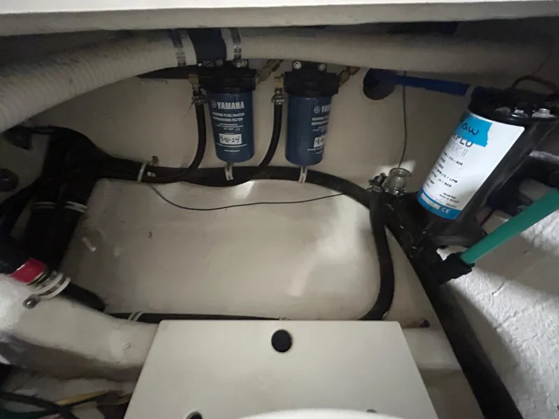 Slide: The Image of Engine compartment of 2019 Albemarle 27 Dual Console boat, showing filters and hoses. - 45
