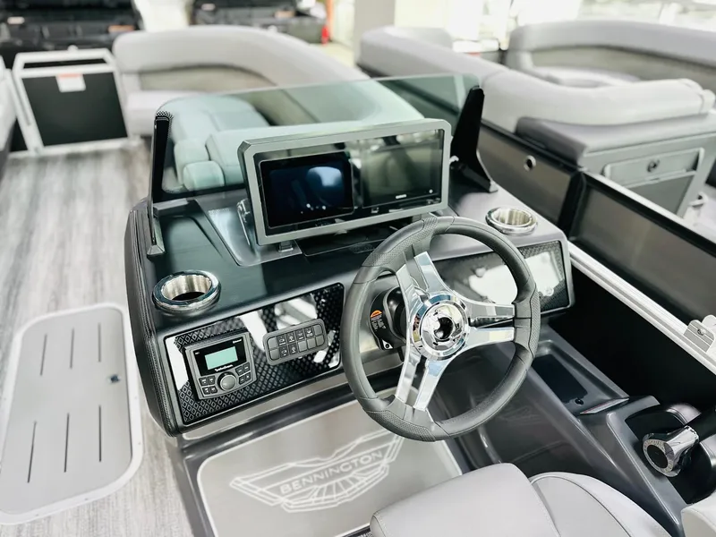 Slide: The Image of 2025 Bennington 24 MFB boat dashboard with steering wheel and digital display. - 3
