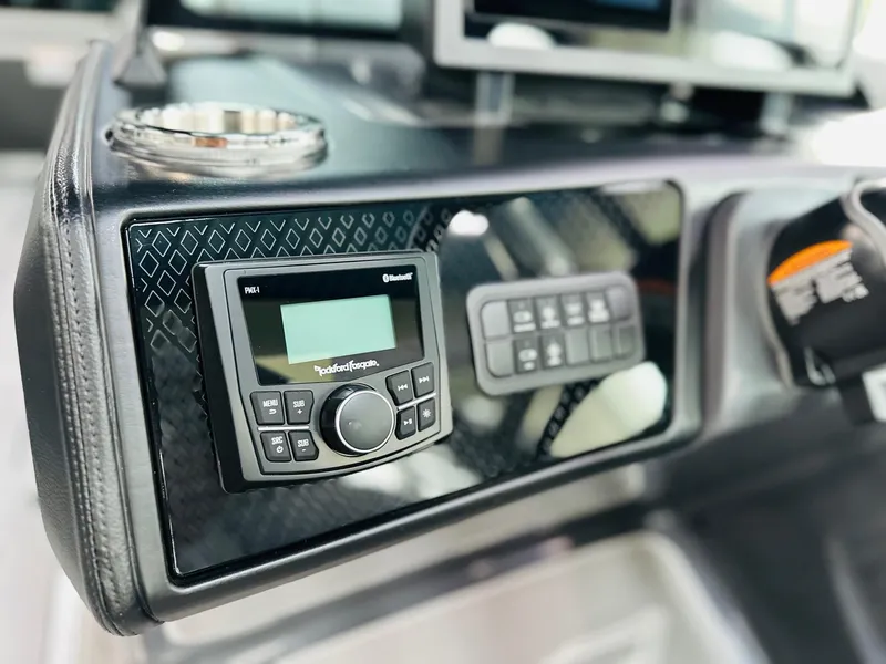 Slide: The Image of Dashboard of 2025 Bennington 24 MFB with audio controls and cup holder. - 4