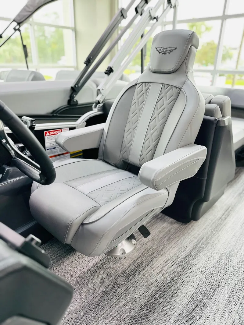 Slide: The Image of Luxurious captain's chair in 2025 Bennington 24 MFB boat, featuring elegant gray upholstery. - 5