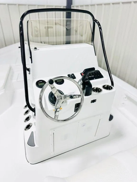 Slide: The Image of 2025 Frontier 2104 boat console with steering wheel and controls. - 2