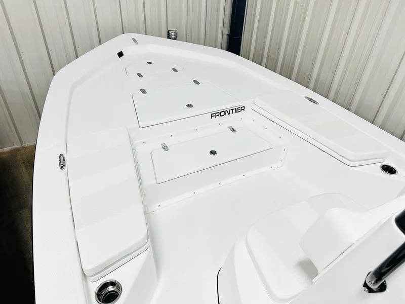 Slide: The Image of 2025 Frontier 2104 boat deck, white finish, spacious layout, indoor storage setting. - 5