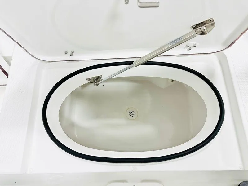 Slide: The Image of Open storage compartment in Frontier 2104, 2025 model, with oval design and secure hinge. - 9