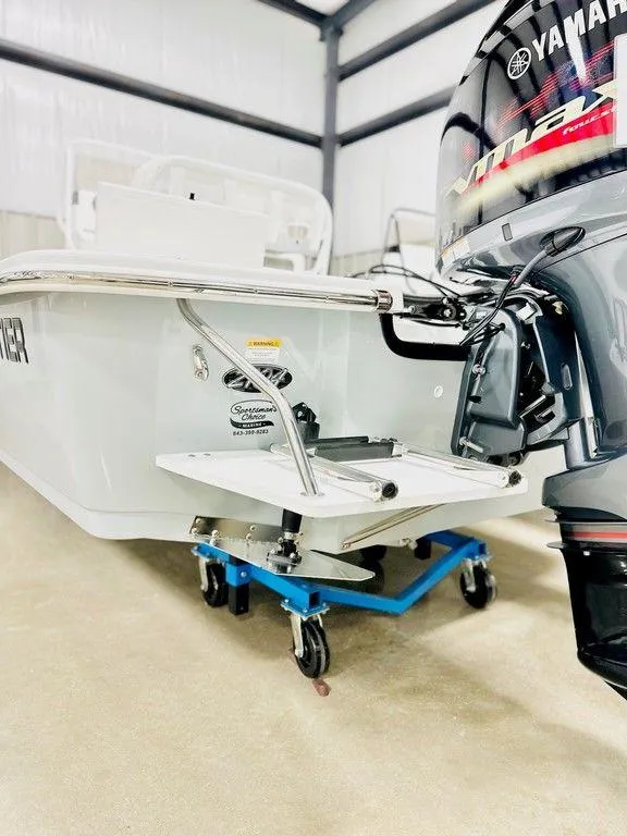 Slide: The Image of 2025 Frontier 2104 boat with Yamaha engine in a garage setting. - 10