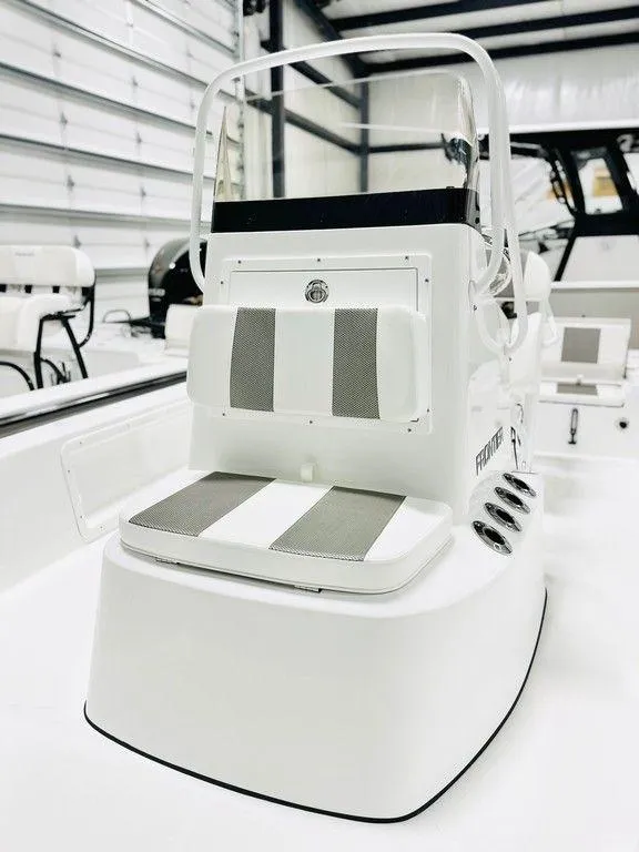 Slide: The Image of 2025 Frontier 2104 boat interior with striped seating in a showroom. - 5