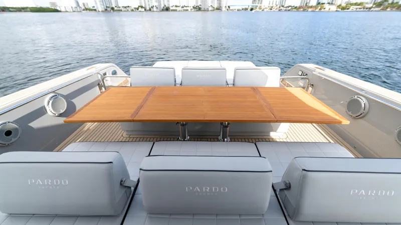Slide: The Image of Luxury seating area on 2024 Pardo Yachts 43, featuring elegant wooden table and waterfront view. - 23