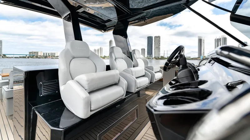 Slide: The Image of 2024 Pardo Yachts 43 interior with luxurious seating and modern helm, city skyline in background. - 29