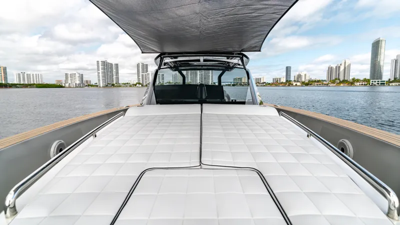 Slide: The Image of 2024 Pardo Yachts 43 with spacious deck and canopy, city skyline in background. - 32