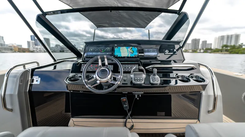 Slide: The Image of 2024 Pardo Yachts 43 helm with modern controls and city skyline in background. - 34