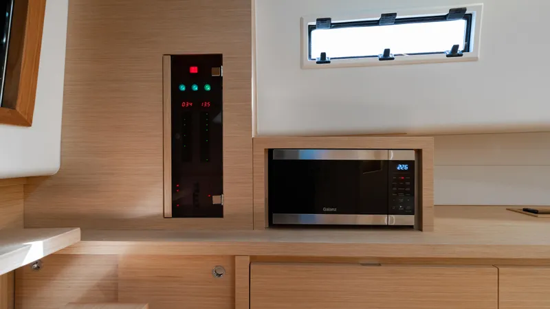 Slide: The Image of Interior of 2024 Pardo Yachts 43 featuring a microwave and control panel. - 38