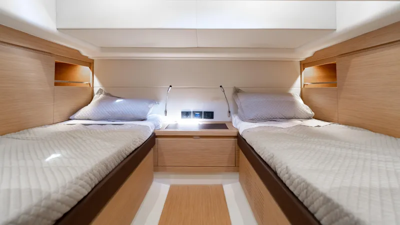 Slide: The Image of 2024 Pardo Yachts 43 interior cabin with twin beds and modern wooden design. - 41