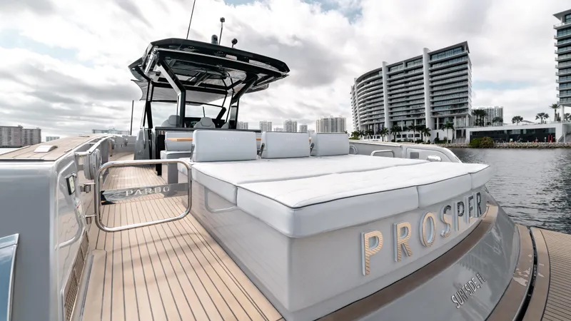 Slide: The Image of 2024 Pardo Yachts 43 luxury yacht with spacious deck and modern design, docked near waterfront buildings. - 14