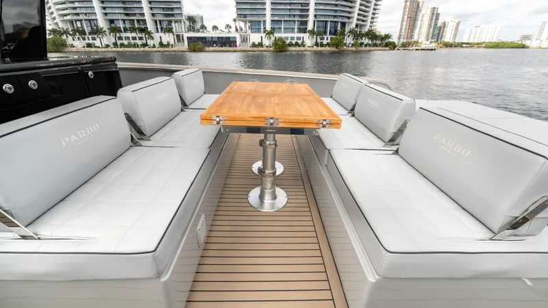Slide: The Image of Luxurious seating area on 2024 Pardo Yachts 43 with wooden table and waterfront view. - 26