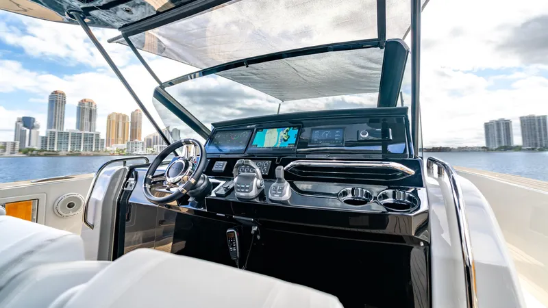 Slide: The Image of 2024 Pardo Yachts 43 helm with modern controls and city skyline backdrop. - 31