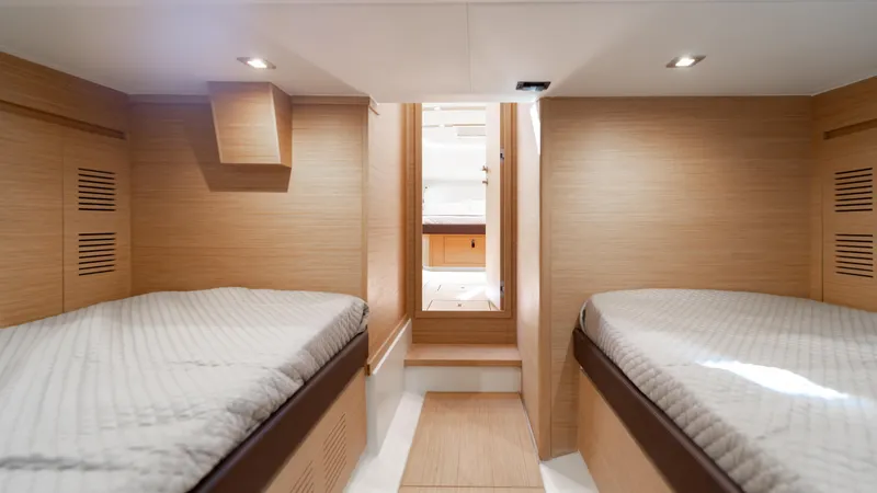 Slide: The Image of 2024 Pardo Yachts 43 interior cabin with twin beds and modern wood finish. - 42