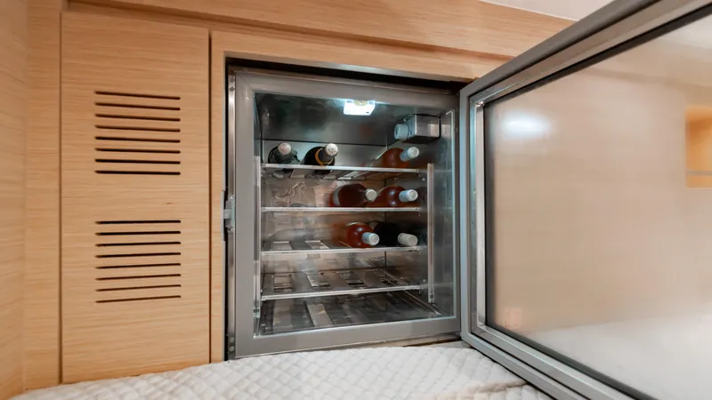Slide: The Image of Mini fridge with wine bottles inside Pardo Yachts 43, 2024 model. - 43