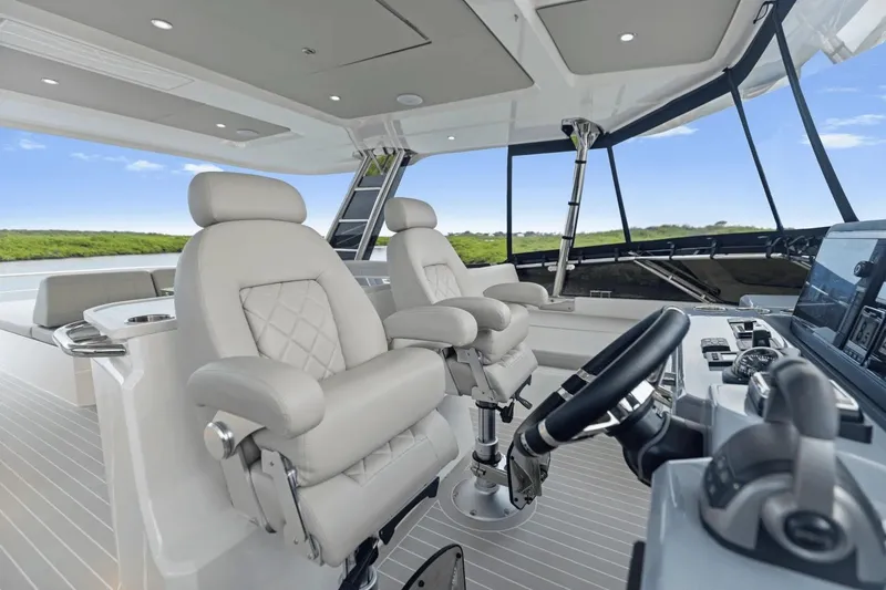 Slide: The Image of Luxurious interior of 2026 Aquila 50 Yacht with modern helm and plush seating. - 16