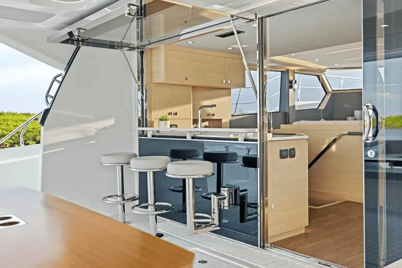 Slide: The Image of Modern interior of 2026 Aquila 50 Yacht with sleek kitchen and bar stools. - 29