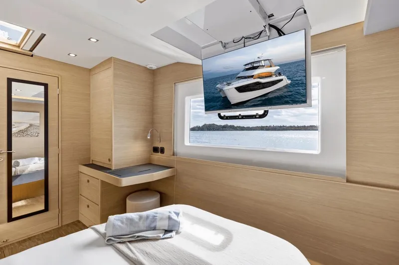 Slide: The Image of Luxurious interior of 2026 Aquila 50 Yacht cabin with TV and scenic window view. - 35