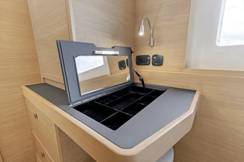 Slide: The Image of Modern vanity area on 2026 Aquila 50 Yacht with mirror and storage compartments. - 36