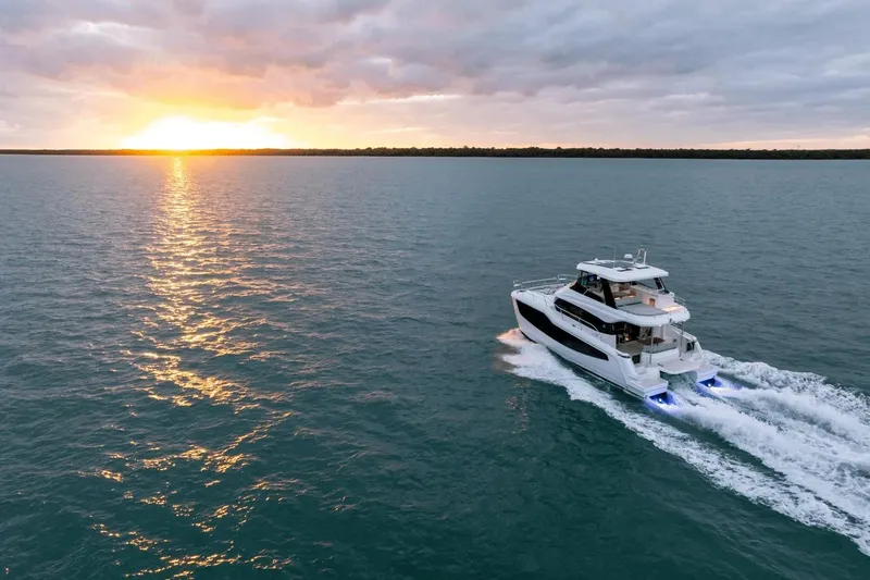 Slide: The Image of Aquila 50 Yacht 2026 cruising at sunset on open water. - 56