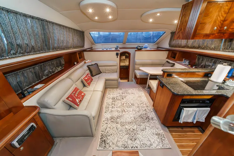 Slide: The Image of Luxurious interior of a 2006 Cruisers 415 yacht with elegant seating and kitchen area. - 16