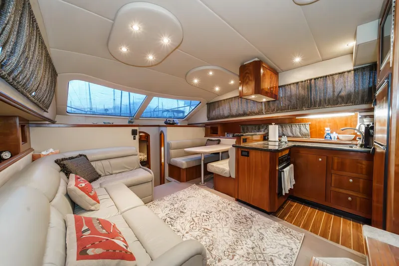 Slide: The Image of Luxurious 2006 Cruisers 415 yacht interior with elegant seating and modern kitchen. - 18
