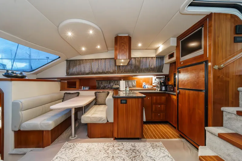 Slide: The Image of Luxurious 2006 Cruisers 415 yacht interior with modern kitchen and dining area. - 19